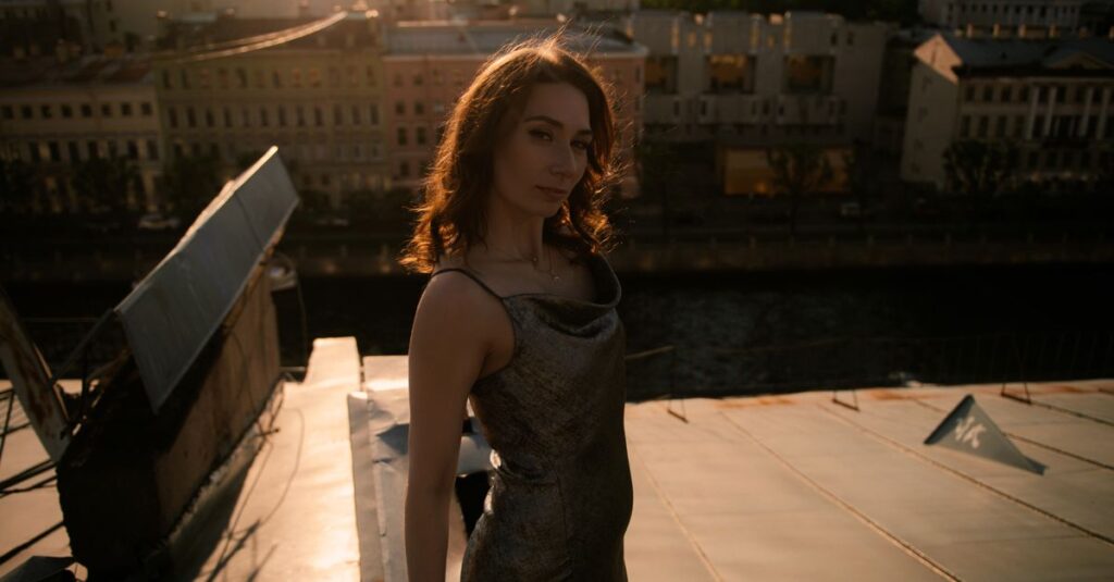 Happy woman on rooftop at golden hour